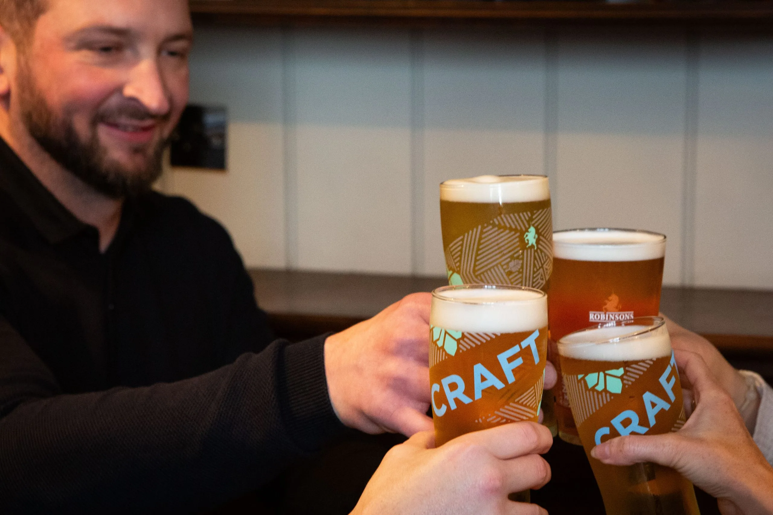 Several people clinking beer