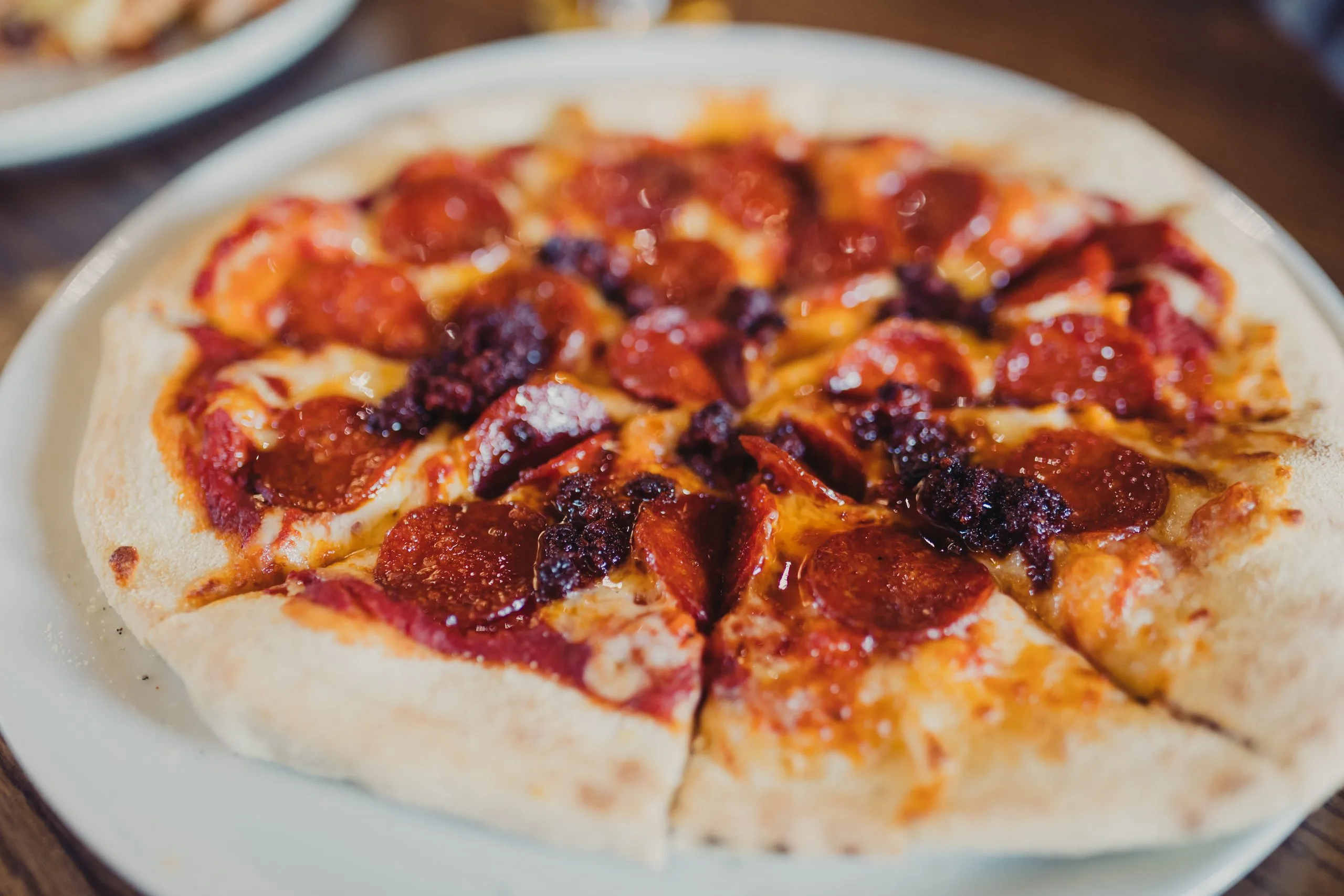 A plate with pepperoni pizza on it